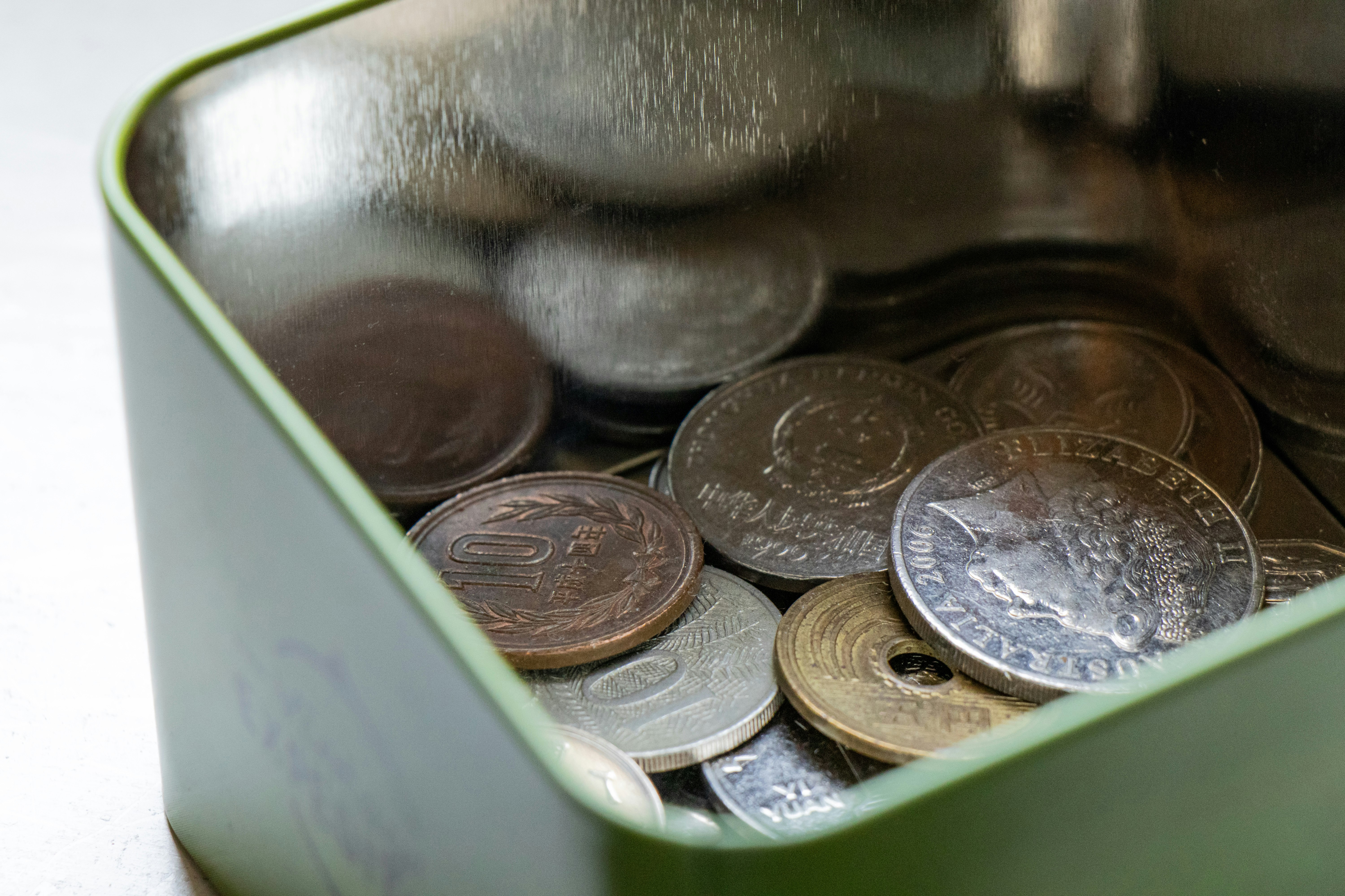 silver round coins on green container